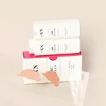 Pro XN ABC Cream SPF 50 - dwa opakowania kremu koloryzującego z widoczną konsystencją odcieni Light Beige i Beige